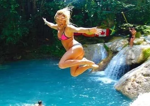Guest jumping into the water at Blue Hole Jamaica