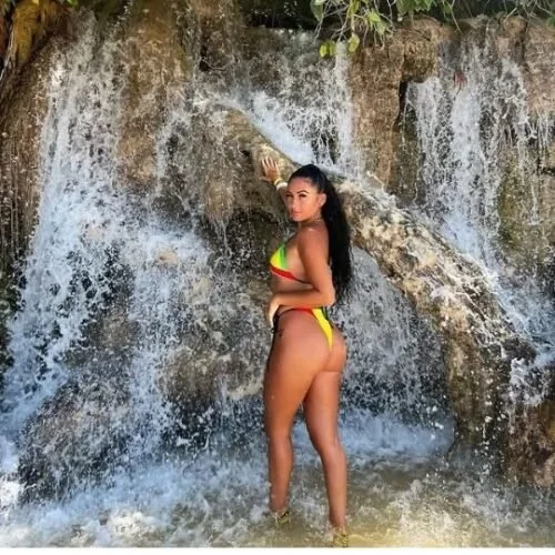 Guest standing beside the Dunn's River Falls cascades