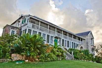 Historic Jamaican great house surrounded by tropical plants