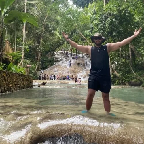Romaine Tours guest at a waterfall in Jamaica