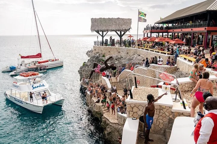 Boats and visitors at a lively Negril waterfront
