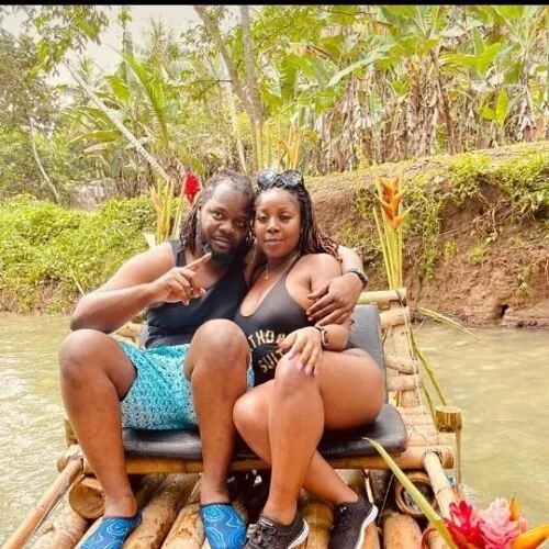 Guests smiling together on a bamboo raft in Jamaica